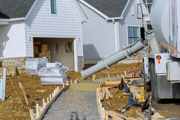 the concrete mixer is pouring sidewalk
