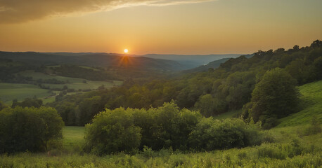 Sun setting over lush green rolling hills and forest