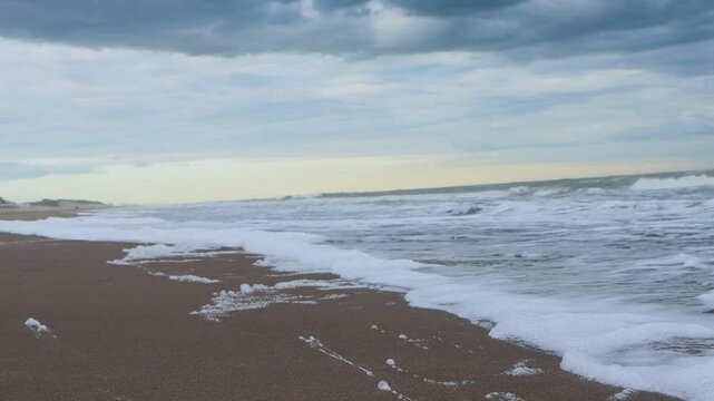 A beach with a large wave in the water in Carilo, Buenos Aires, Argentina, 4K Ultra HD