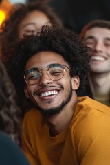 Obraz premium Smiling man, glasses, curly hair, group setting.