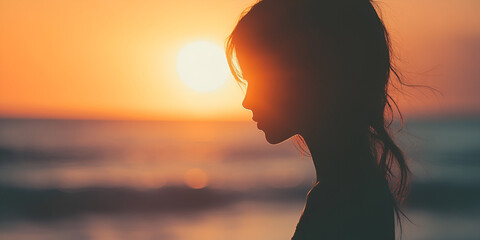 Profile of a Woman's Silhouette Against Ocean Sunset