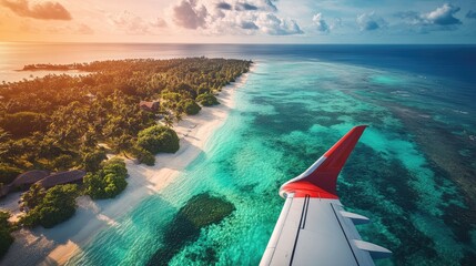 Aerial view of a tropical island with clear waters and a plane wing.