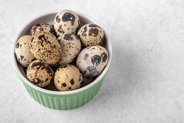 A dish with quail eggs placed on a textured surface. Concept of healthy eating.