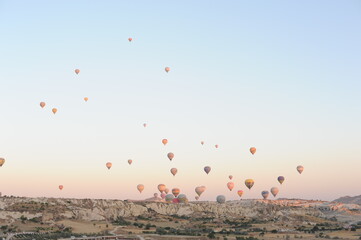 Hot air balloons flying over blue sky on a sunny morning in Cappadocia, Turkey