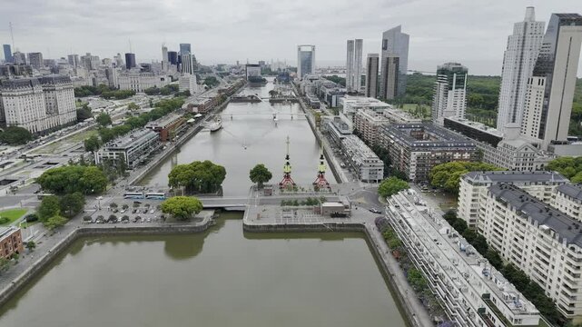 Drone lowers as it orbits over Rio Darsena Sur in Puerto Madero in Buenos Aires, Argentina