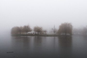 Fototapeta premium Foggy Island in the lake