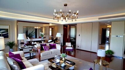 Luxurious modern living room featuring vibrant purple accents, elegant furniture, contemporary lighting, and a warm, stylish ambiance.