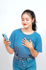 Fototapeta premium Happy mindful thankful young woman holding hands on chest smiling isolated on white background feeling no stress, gratitude, mental health balance, peace of mind concept.