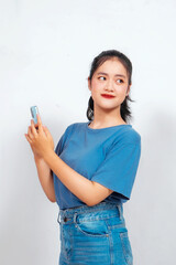 Fototapeta premium Smiling young Asian woman employee holding her phone, isolated on white background