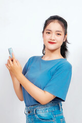 Fototapeta premium Smiling young Asian woman employee holding her phone, isolated on white background