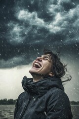 Person joyfully faces stormy rain, windblown hair.