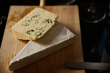 Selection of gourmet cheeses presented on a wooden cutting board