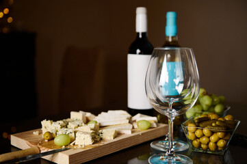 Elegant table setup featuring wine bottles, cheese platter, and appetizers