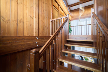 An Elegant Wooden Staircase Bathed in Beautiful Natural Light Creates a Warm Atmosphere