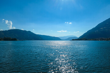 Breathtaking view of Lake Ossiach surrounded by majestic mountains and rolling hills of Ossiacher Tauern in Carinthia, Austria, Europe. Serene and idyllic scene in Austrian Alps in summer