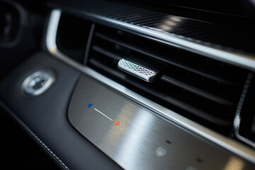 Closeup of car dashboard air vents near gear shift