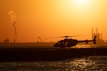Helicopter at heliport during sunset