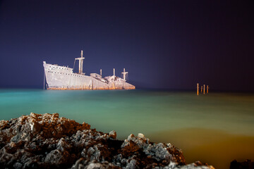 wrecked beached cargo ship on the coast lines in persian gulf kish island  