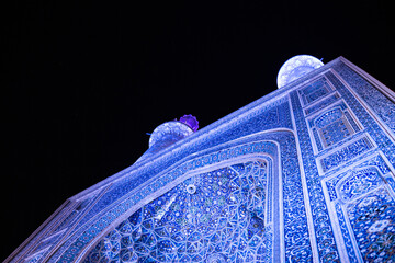 The Jāmeh aka jame Mosque of Yazd beautiful persian architecture with mosaic tile work ceramic geometric shapes minarets islamic architecture at night 