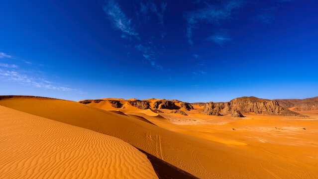 Tadrart Rouge, meaning Red Mountain, a mountain range in southeastern Algeria, part of the Algerian Desert providing massive dunes, rock formations and Martian landscapes