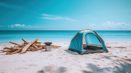 Fototapeta premium Camping by the serene beach with a tent and firewood under a clear blue sky at noon
