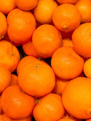 Vibrant display of fresh oranges ready for market in a sunny locale