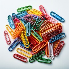 A pile of colorful paper clips arranged neatly, isolated on a white background.