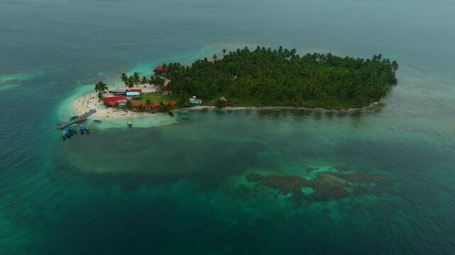 Aerial view of a beautiful tropical island with palm forest and dock in the Caribbean Sea. San Blas Islands In Panama. drone shot