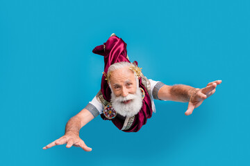 Photo of crazy funny man rome emperor ancient antique philosopher fly air isolated on blue color...