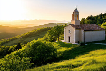 Serene countryside view at sunset featuring a quaint chapel surrounded by lush green hills