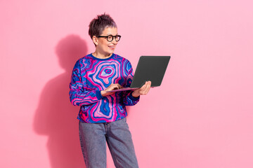 Photo portrait of lovely pensioner lady hold netbook dressed blue colorful garment isolated on pink...