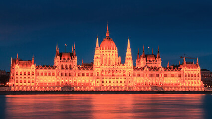 Evening cityscape - view of the Hungarian Parliament Building in the historical center of Budapest on the bank of the Danube river, in Hungary
