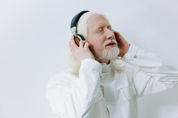 Elderly man enjoying music with headphones, closed eyes, serene expression, white background, light tones, modern aesthetic, peaceful atmosphere, highlighting joy of music listening