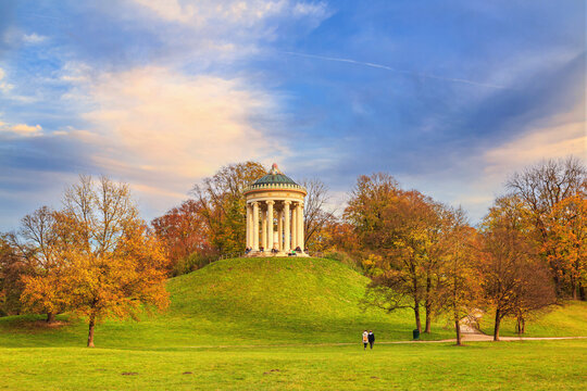 Autumn landscape - view of a monopteros is a circular colonnade on the hill in the Englischer Garten public park in Munich, Bavaria, Germany