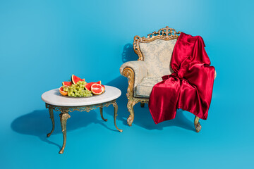 Portrait of luxury ancient furniture exhibition emperor throne fresh fruits table isolated on blue...