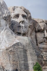 Close-up of Mount Rushmore, showcasing the intricate carving of Presidents' faces into granite....