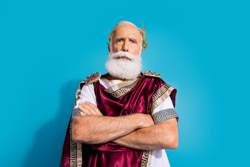 Photo of powerful mature man strict crossed hands confident wear ancient roman emperor tunic...