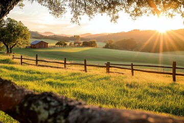 Obraz premium Warm sunlight bathes the tranquil landscape, highlighting a rustic barn and rolling fields at dusk