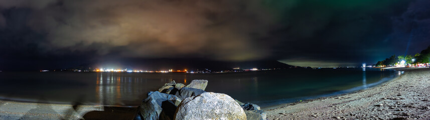 Pereque Beach in Ilhabela, Sao Paulo, Brazil. Sao Sebastiao navigation channel seen at night from the sands of Perequê Beach in Ilhabela.