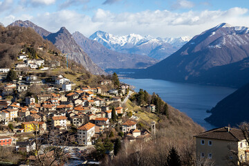 Fototapeta premium View from Monte Bre of the village, Lake Lugano, and surrounding mountains, Switzerland