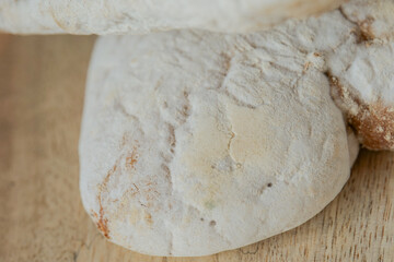 bread with mold on a wooden cutting board. White mold close-up on yeast bread. Stale bread.Expired product expiration date