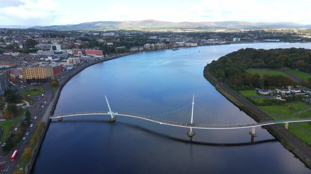 City of Derry aka Londonderry in Northern Ireland aerial view - A Beautiful Cityscape from above by the River Foyle Featuring the Beautiful Pedestrian Peace Bridge