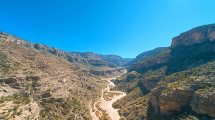 Majestic Canyon Landscape with Serene River and Blue Sky - Dramatic Nature Scenery Photography