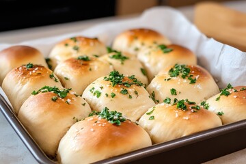 Delicious fluffy bread rolls topped with fresh herbs and golden perfection in a cozy kitchen setting