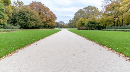 Obraz premium Tranquil park pathway leading through a green lawn with autumn trees