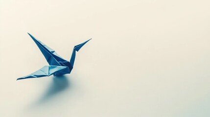 A blue origami crane on a minimalistic background, symbolizing peace and creativity.
