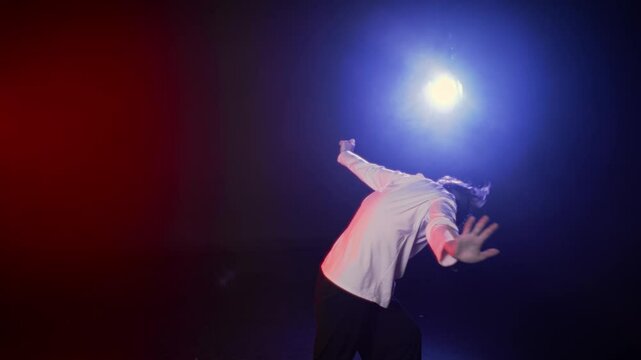 Be in motion, active hobby and passion, woman dancing alone in dance class. Happy young lady enjoying rhythmical music and moving in darkness, red and blue soffits illuminating female dancer figure