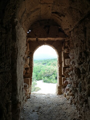 A forest viewed through the entry way of an ancient watch tower in Ibiza Spain 