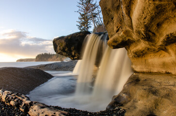 Sandcut Falls, near Sooke BC Canada shines in sunset golden light