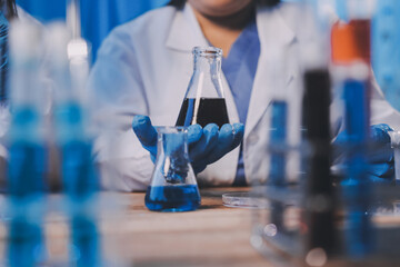 Blood test in the laboratory. Laboratory assistant working with the dispenser. Vacuum tubes with blood.